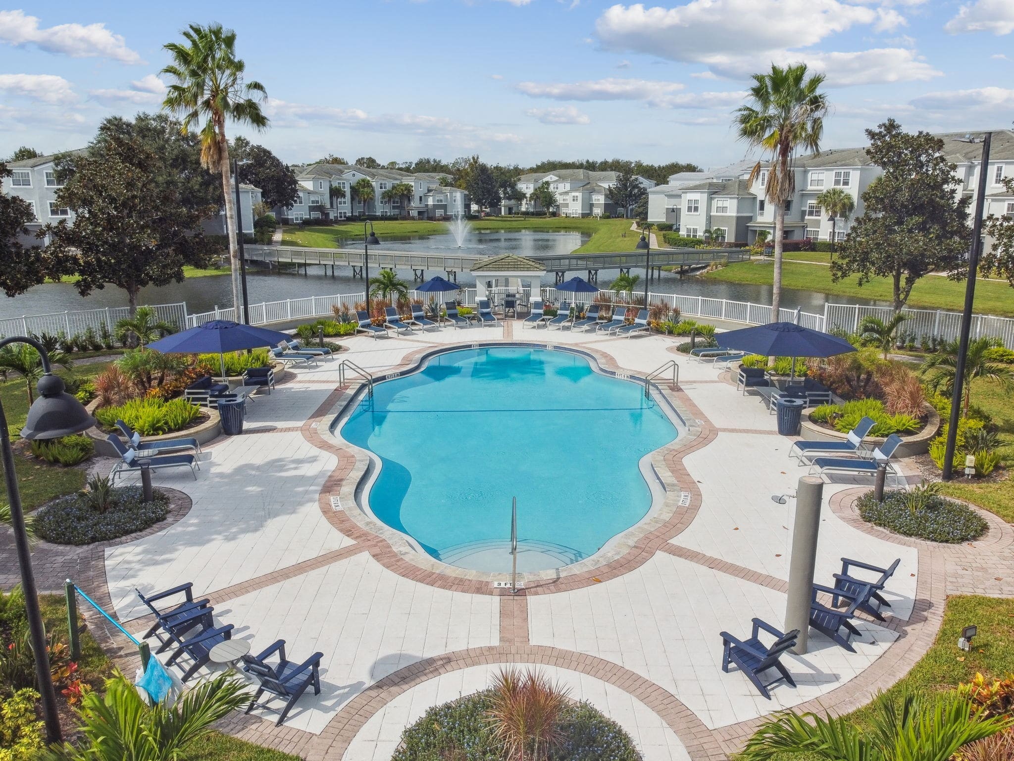 Apartments for Rent in Winter Springs, FL - Eli Winter Springs - Pool with Umbrella Tables and Pond View