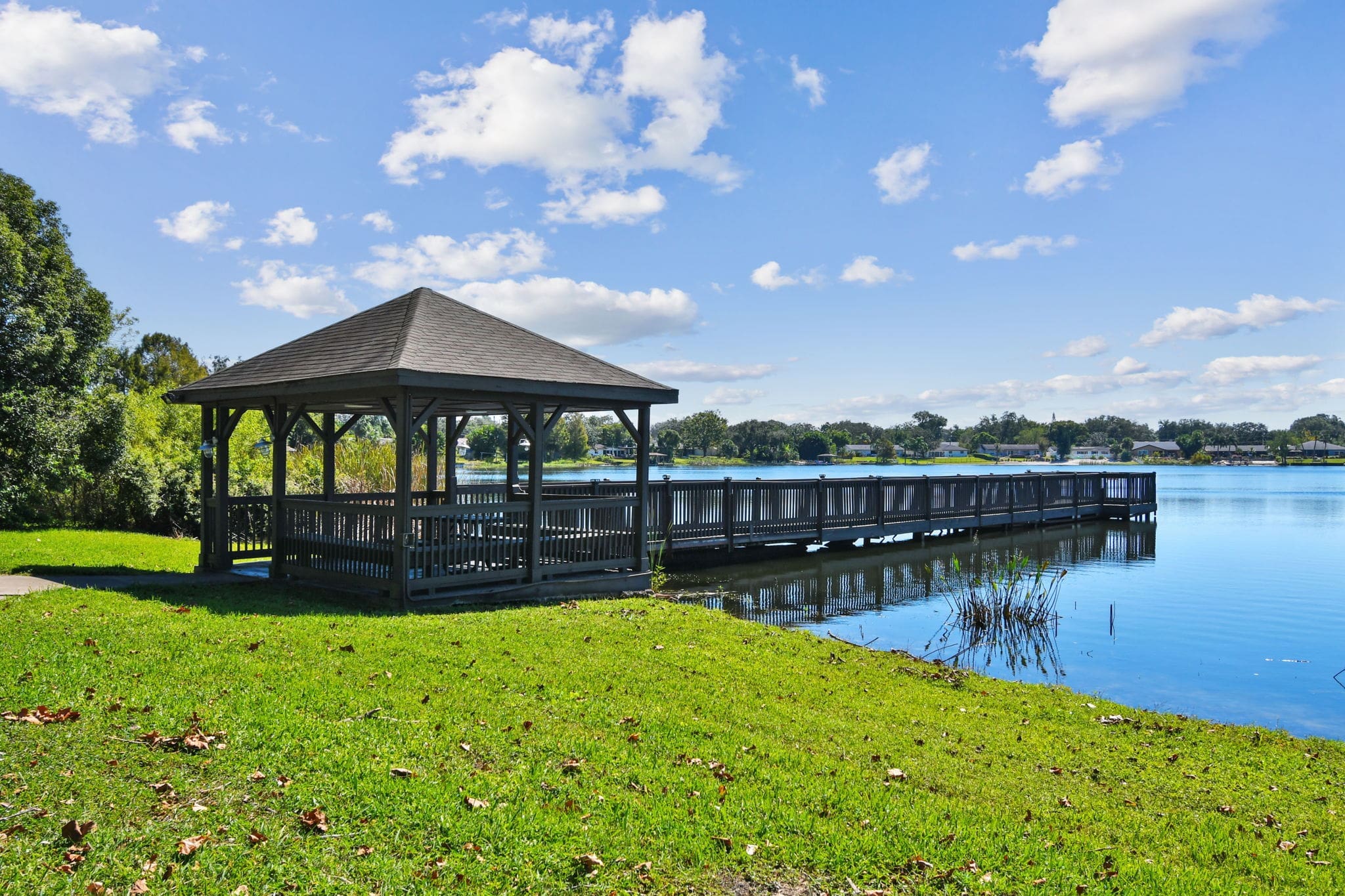 Lake Underhill, FL, Apartments for Rent - Enclave At Lake Underhill Apartments - Private Fishing Pier With Pavilion Overlooking Lake And Houses.